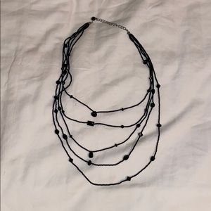 Multi layered black necklace with black beads.